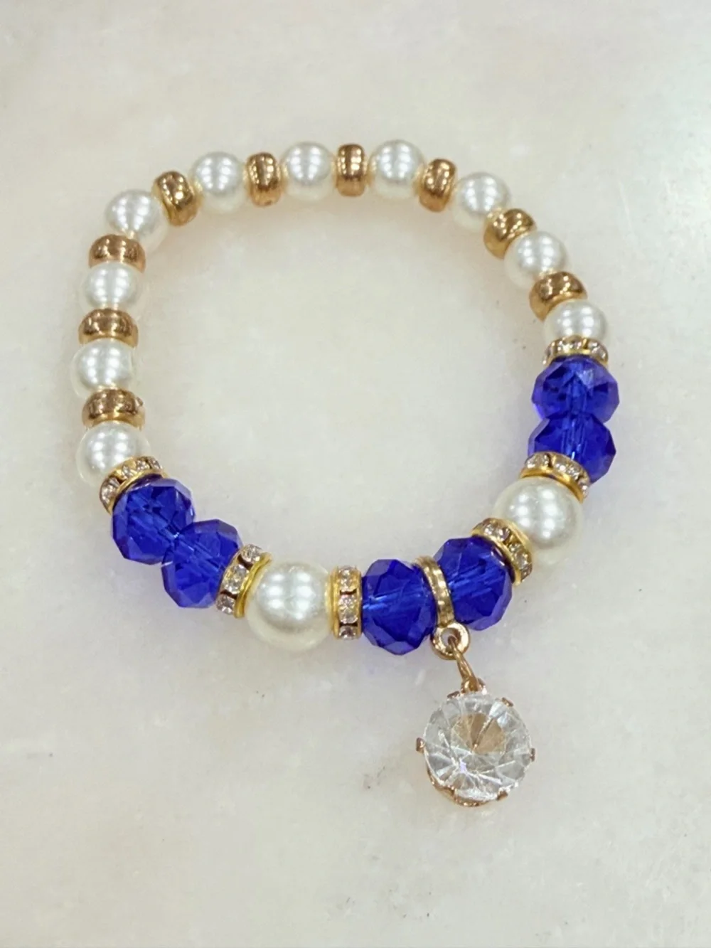 Gold and Pearl Beaded Stretch Bracelet with Blue Crystal Accents and Charm
